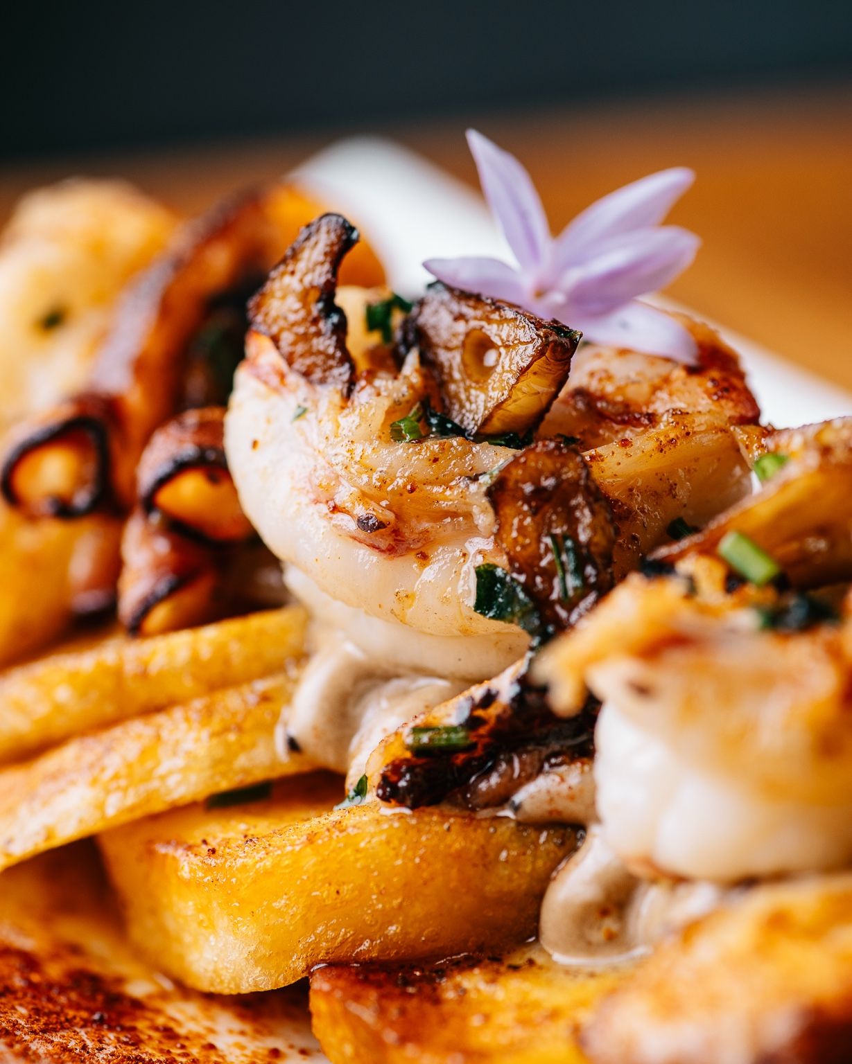 Papas arrieras con langostinos, setas y salsa cremosa, servidas para compartir